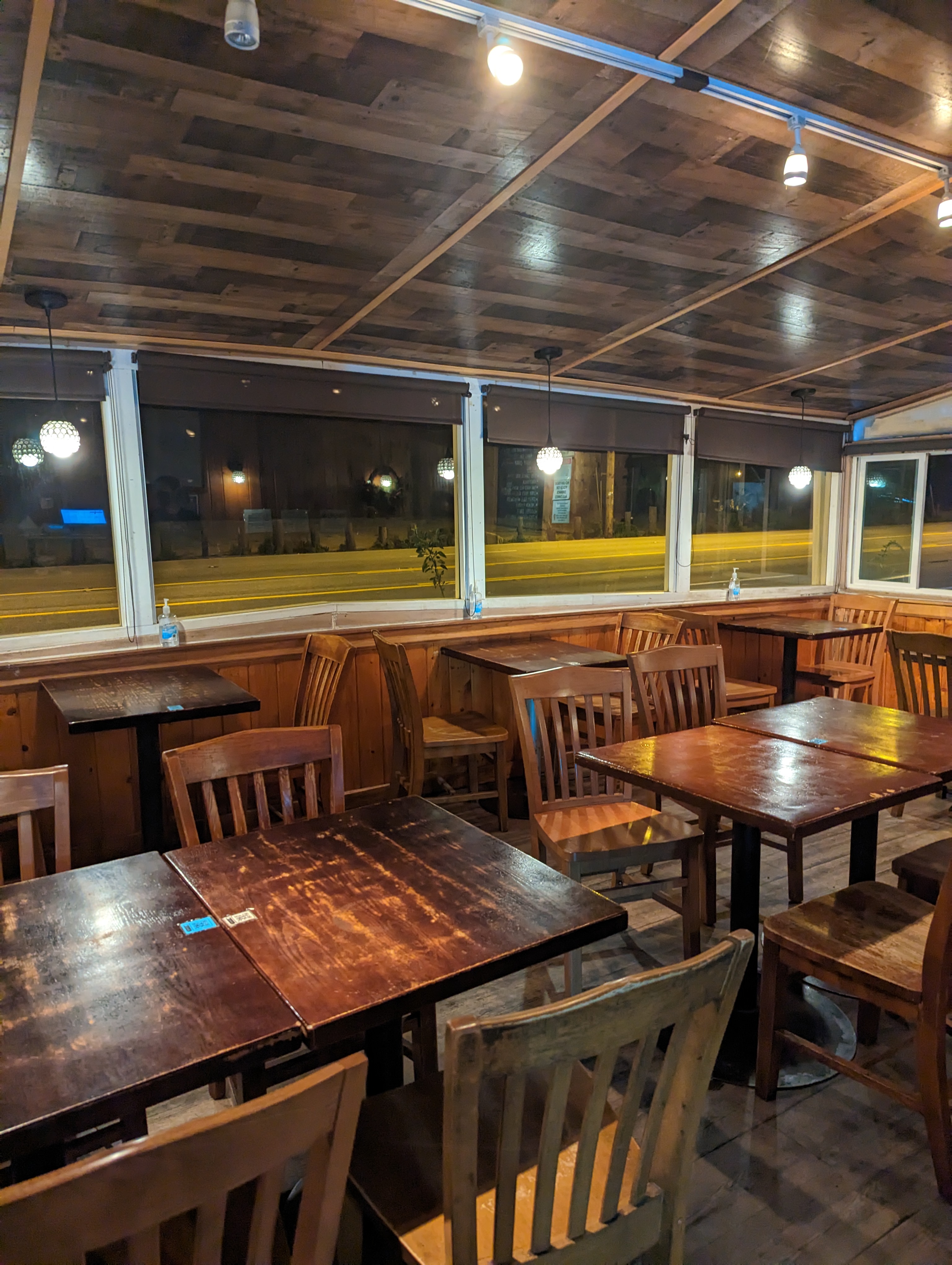 A cozy restaurant dining room with tables set for the evening
